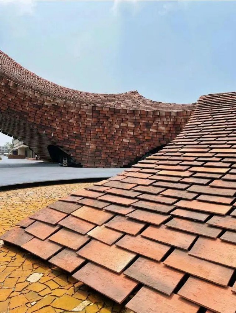 A close-up image of the terracotta panels on the facade of the UCCA Terracotta Art Museum, showing the intricate texture and color variations that enhance the building's aesthetic appeal.