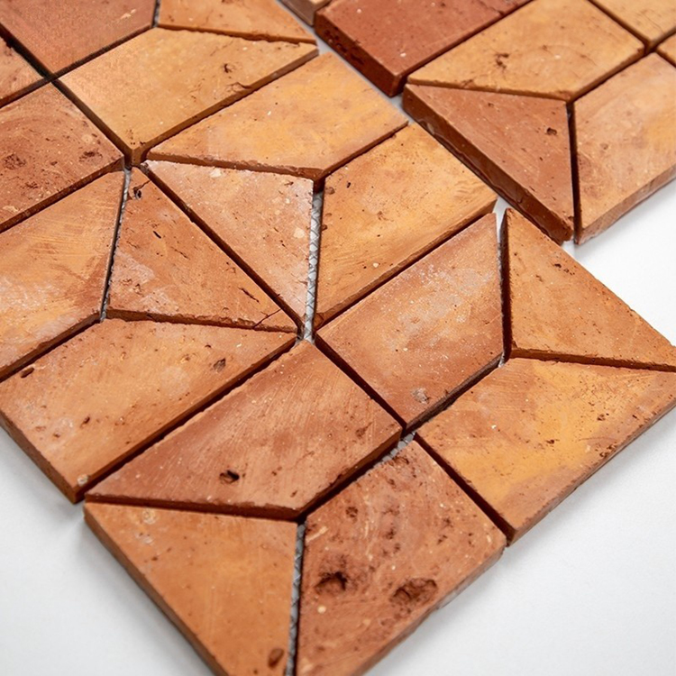 Textured terracotta mosaic tiles in chevron pattern used on modern feature wall
