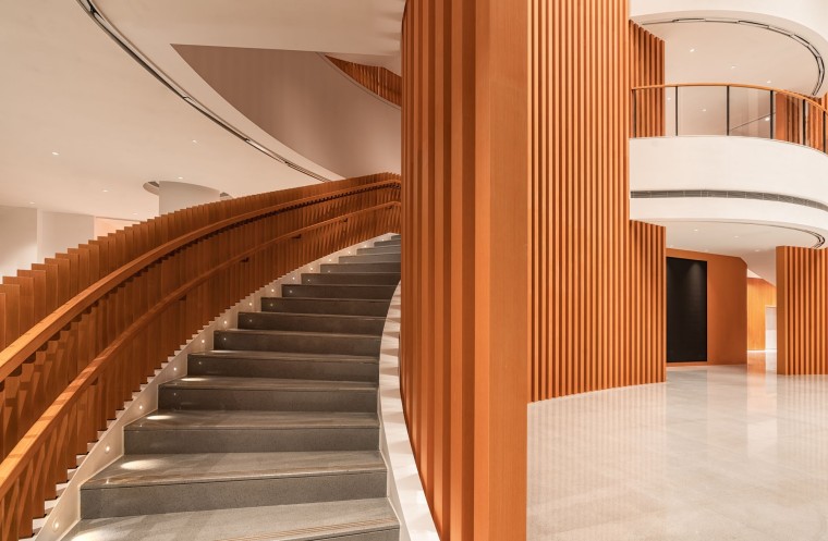Staircase area of Theatre YOUNG with terracotta sunscreens and warm clay wall design